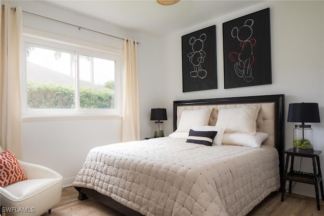 bedroom with hardwood / wood-style floors