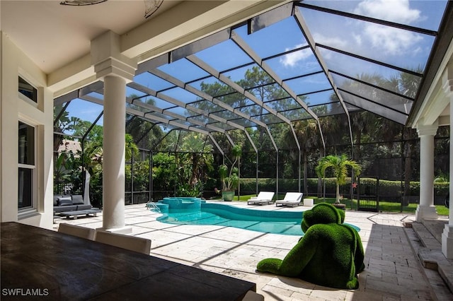 view of pool featuring glass enclosure and a patio area