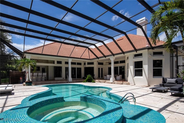 view of pool featuring a lanai, a patio area, outdoor lounge area, and an in ground hot tub