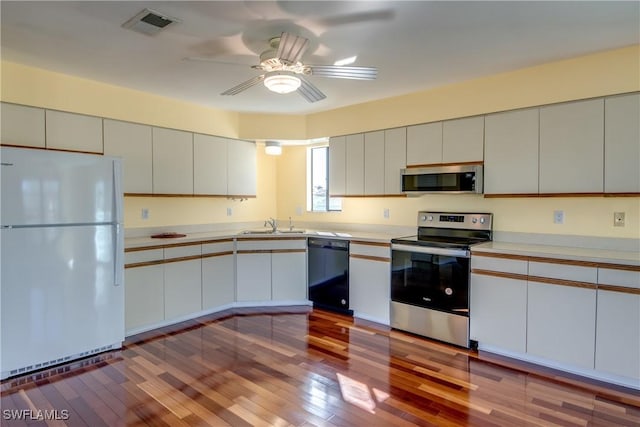 kitchen with ceiling fan, stainless steel appliances, white cabinets, and light wood-type flooring