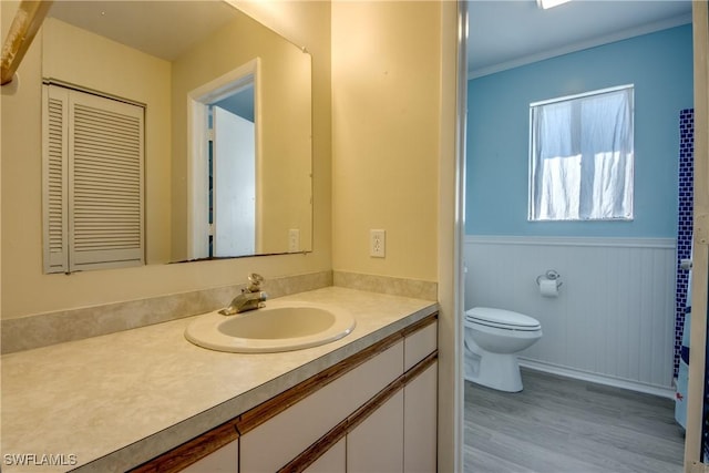 bathroom with vanity, toilet, and hardwood / wood-style floors