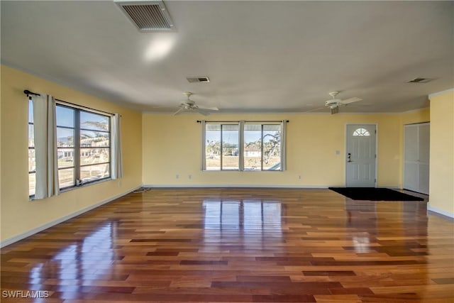 spare room featuring wood-type flooring and ceiling fan