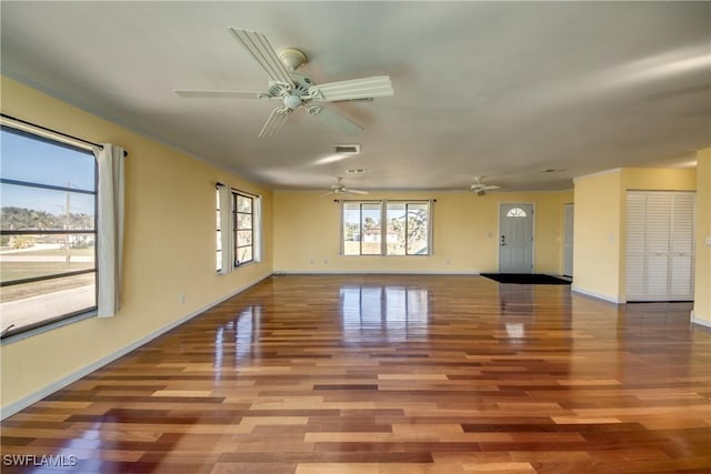 unfurnished living room featuring hardwood / wood-style flooring and ceiling fan