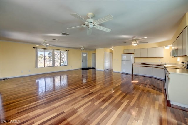 unfurnished living room with ceiling fan and light hardwood / wood-style floors