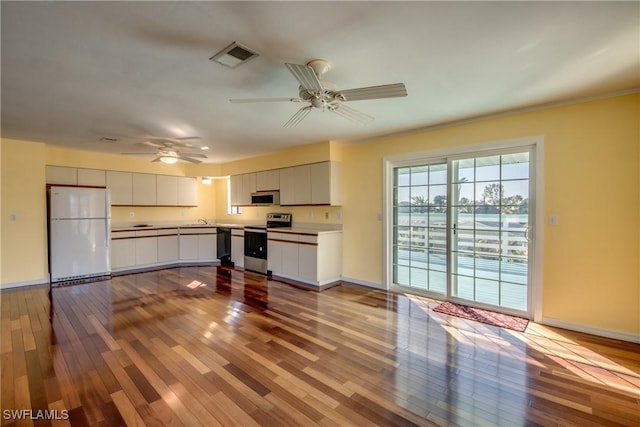 kitchen featuring white cabinetry, ceiling fan, stainless steel appliances, and light wood-type flooring