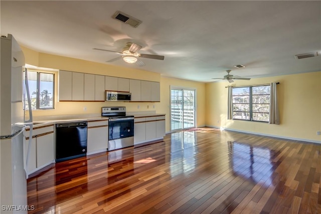 kitchen with ceiling fan, appliances with stainless steel finishes, and light hardwood / wood-style floors