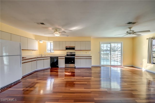 kitchen featuring stainless steel appliances, a wealth of natural light, light hardwood / wood-style flooring, and white cabinets