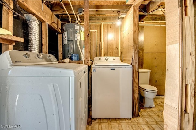 washroom featuring water heater and washing machine and dryer