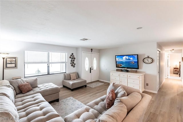 living room with light hardwood / wood-style floors