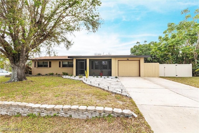 ranch-style house featuring a front lawn and a garage