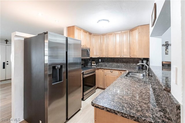 kitchen featuring decorative backsplash, sink, appliances with stainless steel finishes, and kitchen peninsula