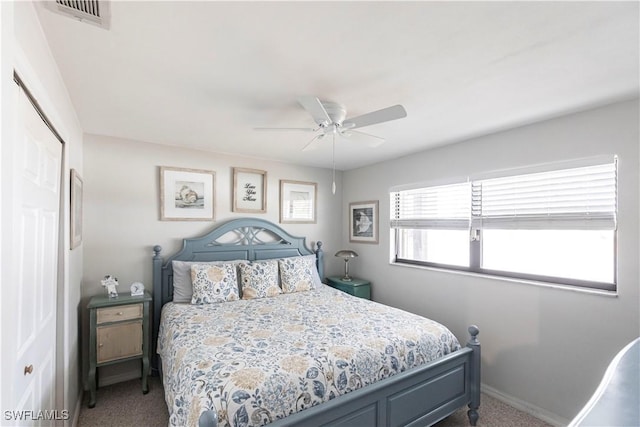 bedroom with ceiling fan, a closet, and carpet flooring