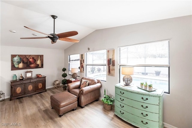 living area with ceiling fan, vaulted ceiling, plenty of natural light, and light hardwood / wood-style flooring