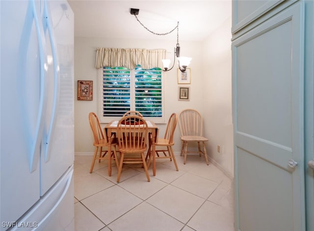 dining area featuring an inviting chandelier and light tile patterned floors