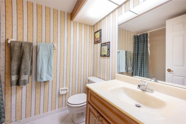 bathroom featuring vanity, tile patterned flooring, and toilet