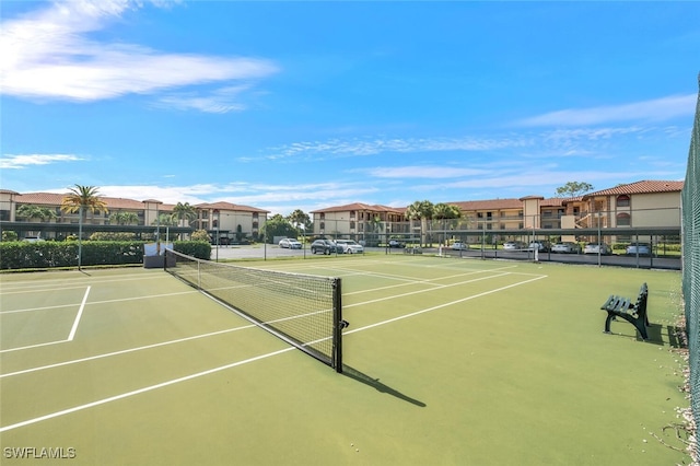 view of tennis court with basketball hoop