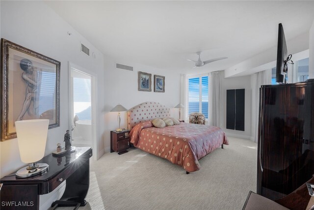 carpeted bedroom with multiple windows, visible vents, and a ceiling fan