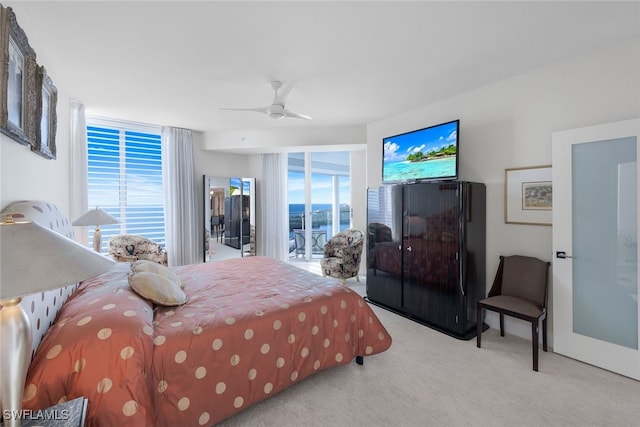 carpeted bedroom featuring access to outside and ceiling fan