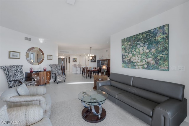 living room with visible vents and a chandelier