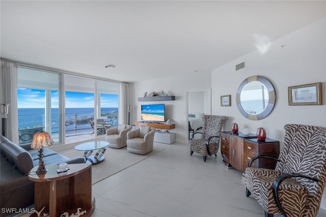 living room featuring expansive windows and visible vents