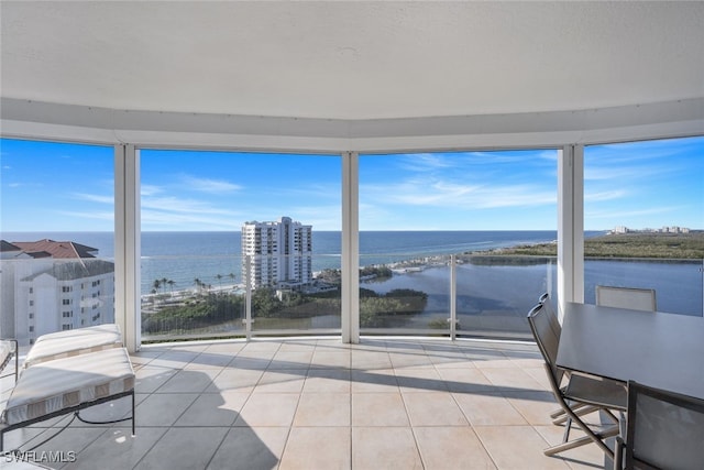 sunroom / solarium with a water view