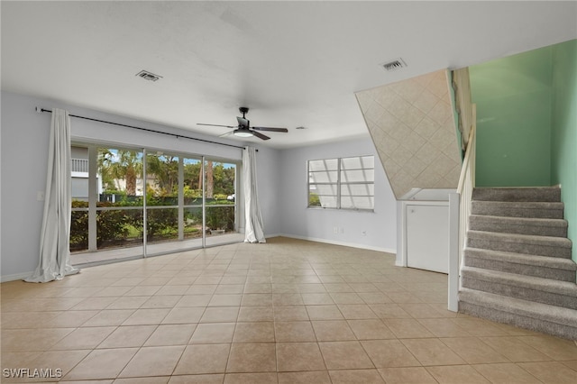 unfurnished living room featuring light tile patterned floors and ceiling fan