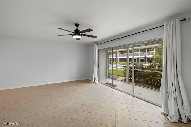 tiled spare room with ceiling fan