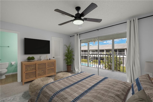 bedroom with ensuite bath, light colored carpet, a textured ceiling, ceiling fan, and access to exterior