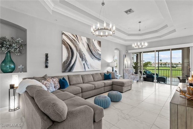 living room featuring crown molding, a tray ceiling, and a notable chandelier