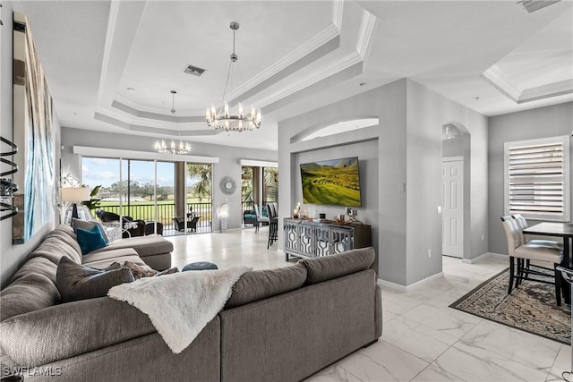 living room featuring a raised ceiling, a notable chandelier, and crown molding