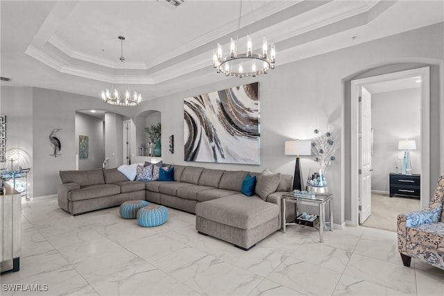 living room with a raised ceiling, a chandelier, and ornamental molding