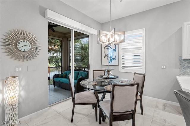 dining space featuring a notable chandelier and a healthy amount of sunlight