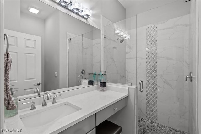 bathroom featuring an enclosed shower and vanity