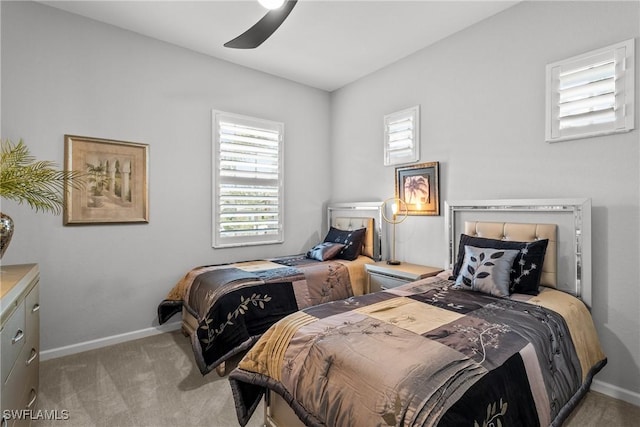 bedroom with ceiling fan and light colored carpet