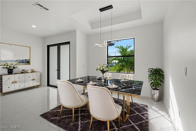 dining space featuring a tray ceiling