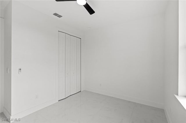 unfurnished bedroom with a closet and ceiling fan