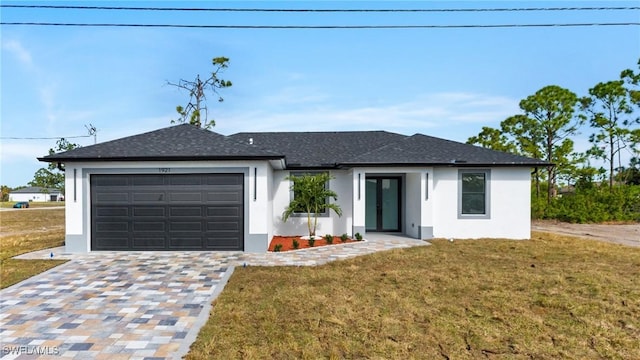 ranch-style home featuring a garage and a front yard