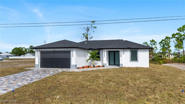 view of front of property featuring a garage and a front lawn