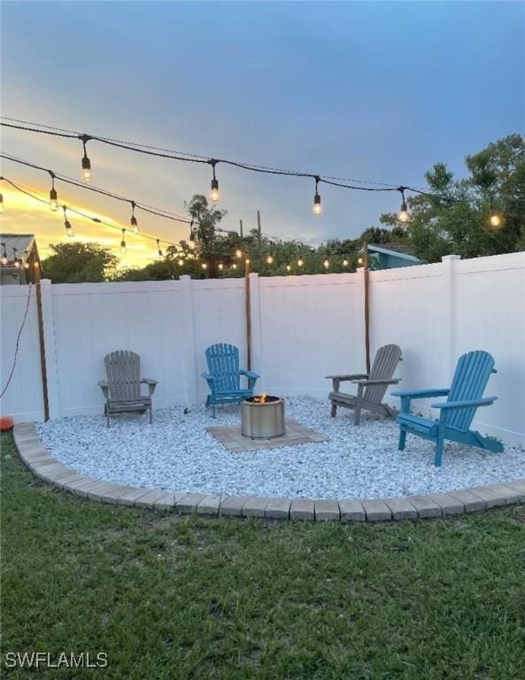 exterior space featuring a lawn and an outdoor fire pit