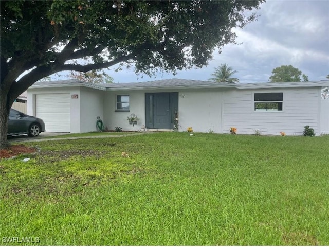 single story home featuring a garage and a front lawn