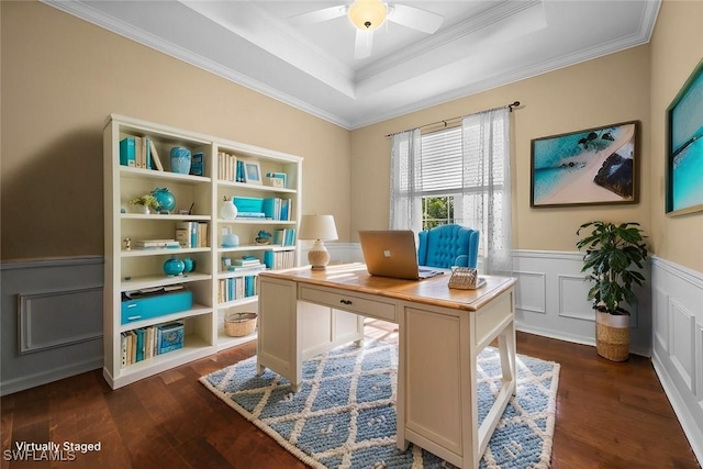 office space with ceiling fan, dark hardwood / wood-style flooring, ornamental molding, and a tray ceiling