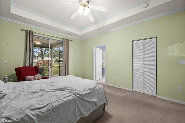 bedroom featuring ceiling fan, light colored carpet, access to exterior, and a tray ceiling