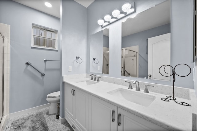 bathroom featuring vanity, toilet, and an enclosed shower