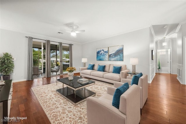 living room with ceiling fan, ornamental molding, and wood-type flooring