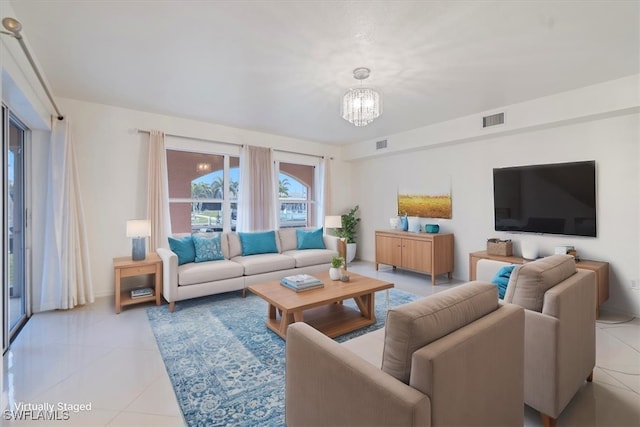 tiled living room featuring an inviting chandelier