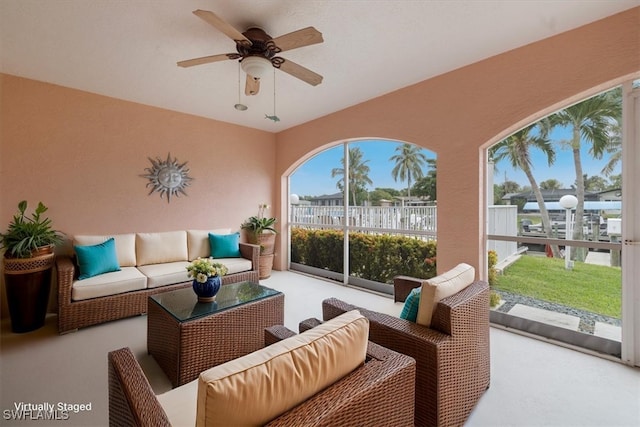 sunroom / solarium featuring ceiling fan