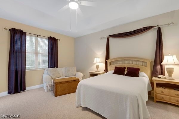 bedroom featuring light carpet and ceiling fan