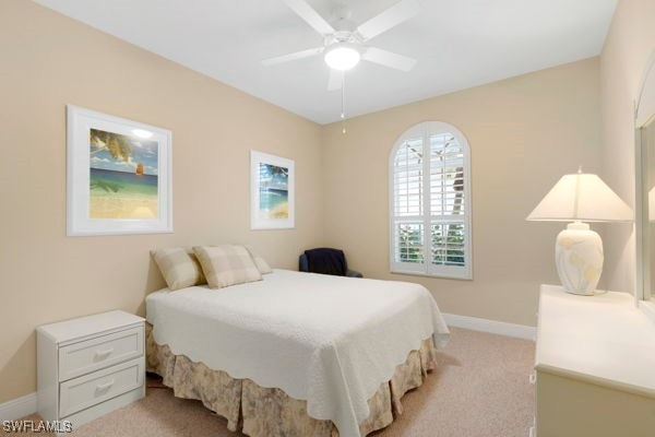 bedroom featuring light carpet and ceiling fan