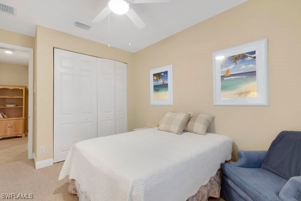 carpeted bedroom with a closet and ceiling fan