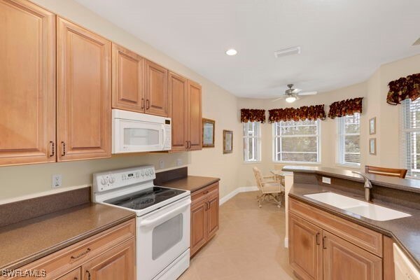 kitchen featuring sink, white appliances, and ceiling fan